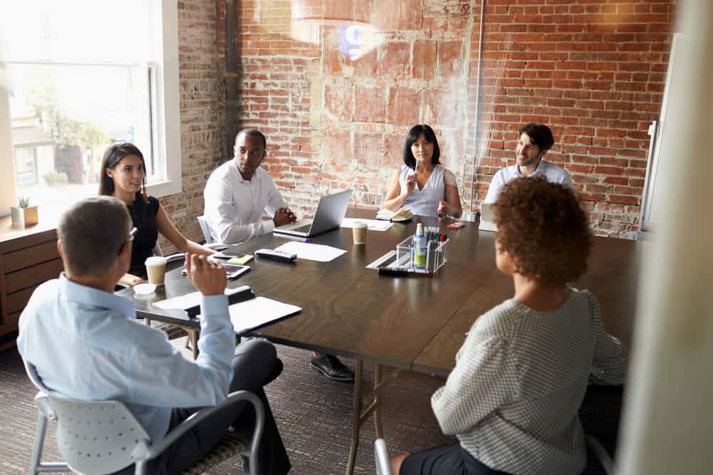 Group Of Business People Meeting In Modern Boardroom